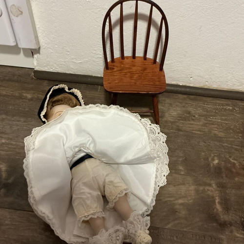 Porcelain doll with velvet dress and wooden chair like new