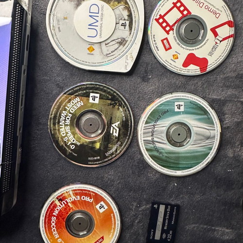 PlayStation Portable PSP-1000 used with charger, 5 games, and Memory Stick