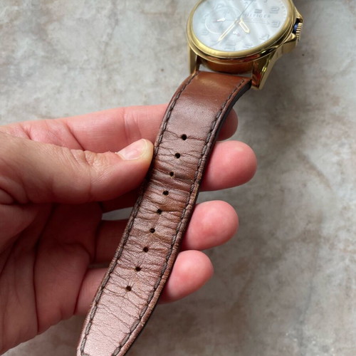 Tommy Hilfiger watch used with brown leather strap and gold dial