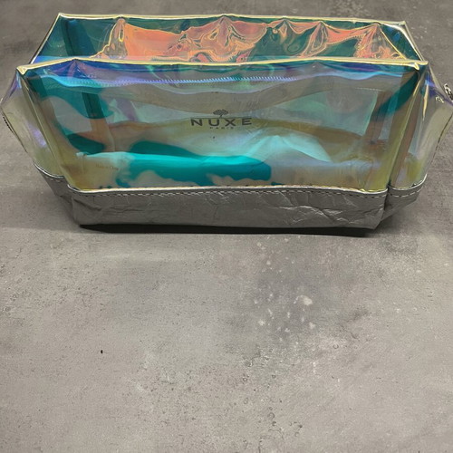 Nuxe holographic makeup bag with silver base