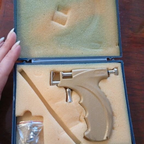 Ear piercing system used with multiple tips and guidance