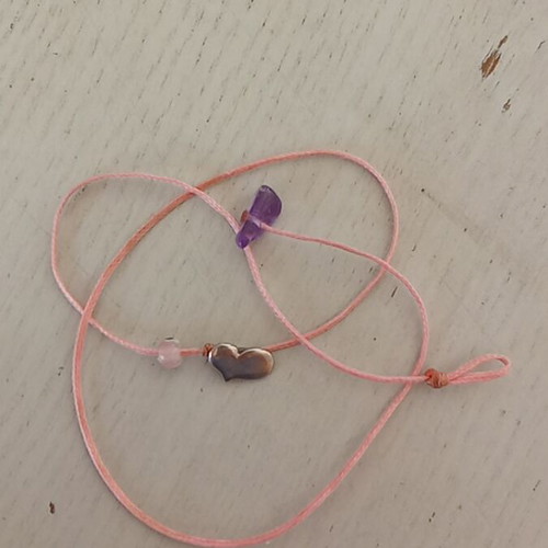 Silver heart pendant with pink eye on pink thread like new