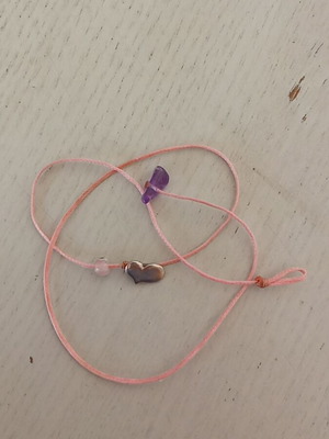 Silver heart pendant with pink eye on pink thread like new