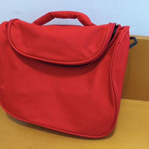Toiletry bag used, red, practical and spacious travel case