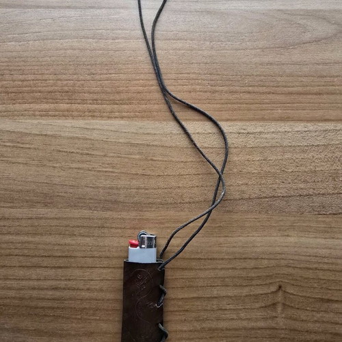 Hanging lighter case like new, carved design