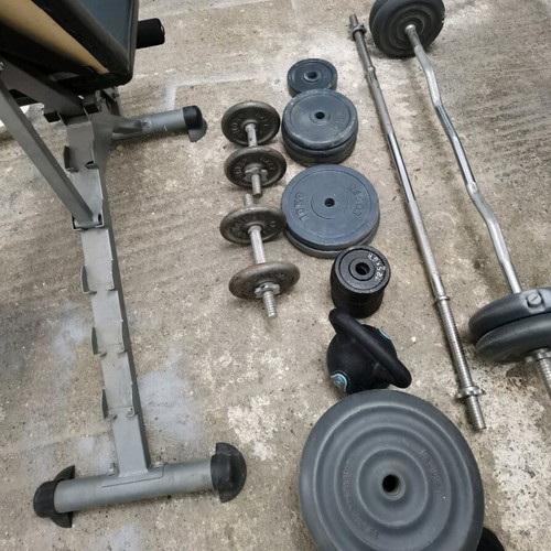 Gym equipment and weights used, set with Amila bench