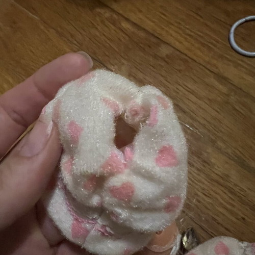 Doll with hood, missing one leg and one arm, slight tear