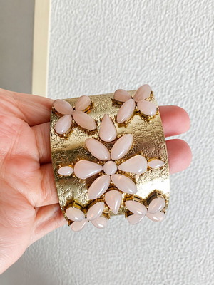 Gold bracelet with pink details