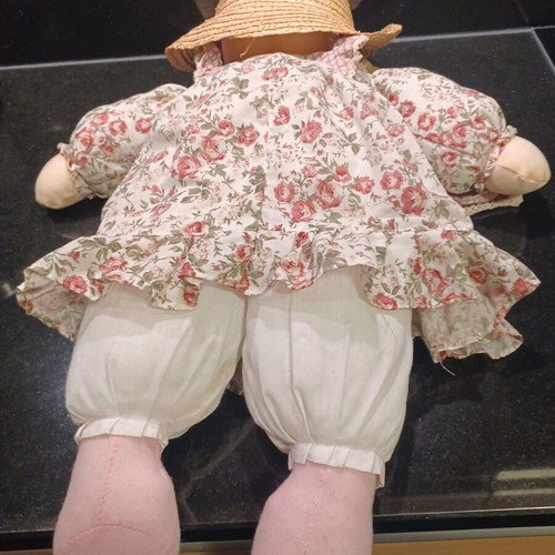 Doll like new with cotton clothes and straw hat