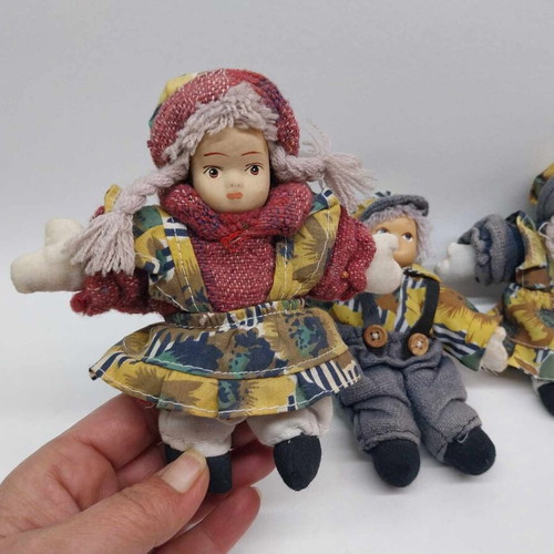 Three small collector dolls with ceramic faces like new