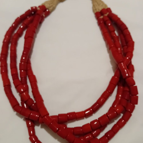 Red multistrand necklace used with cylindrical beads and woven clasp