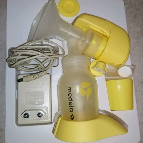 Medela mini electric electric breast pump used with two pumps and chargers