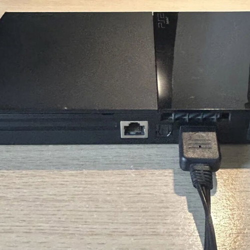 Sony PlayStation 2 Slim console used with DualShock 2 and cables