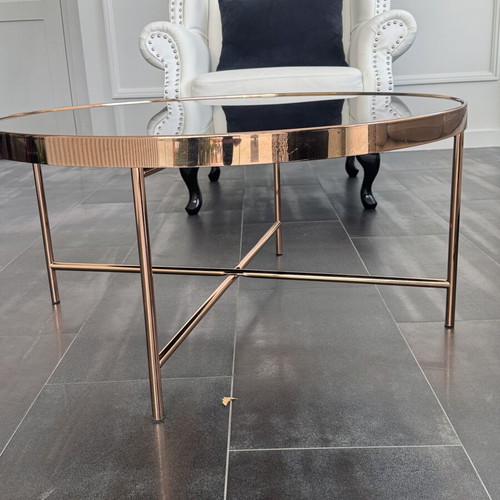 Round coffee table with glass top and metal frame