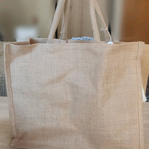 Jute bag with knitted decorative eye and waterproof lining