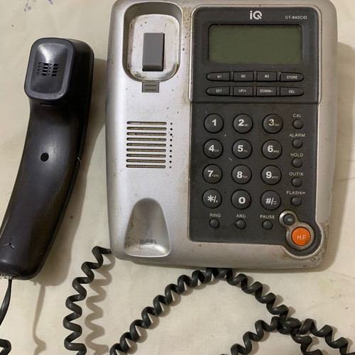 Landline phone old type used, gray, wired