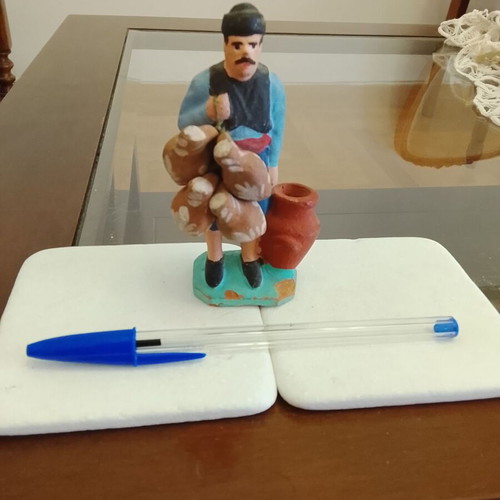 Traditional handmade clay figurine of a villager used