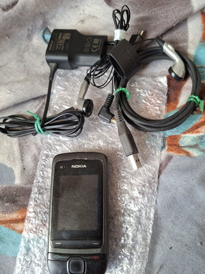 Nokia C2-05 phone with charger, headphones and data cable