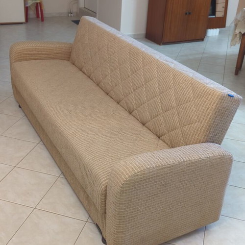Practical three-seat sofa bed like new with storage compartments