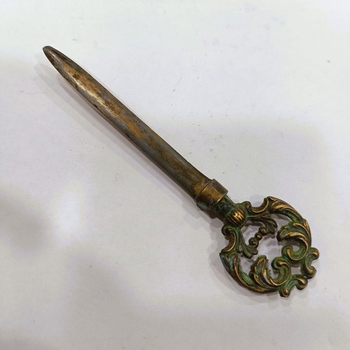 Vintage brass letter opener with embossed baroque handle, used