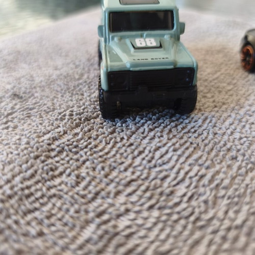 Land Rover Defender and Cord Camaro toy cars, set of 2