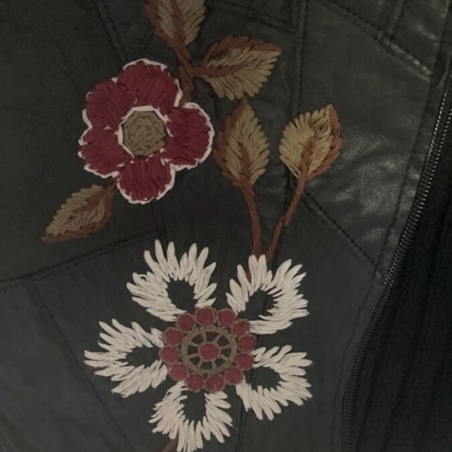Vintage leather jacket used with knitted wool sleeves and embroidered details