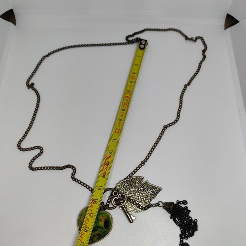 Vintage necklace with antique bronze elements and peacock feather heart pendant like new