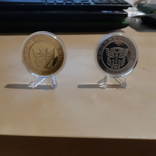Transformers metal coins new, set with acrylic case and stand