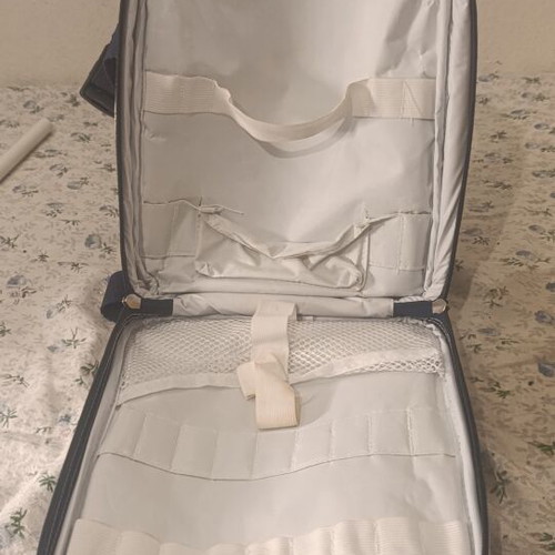 Insulated backpack with bottle holder like new, black and white striped