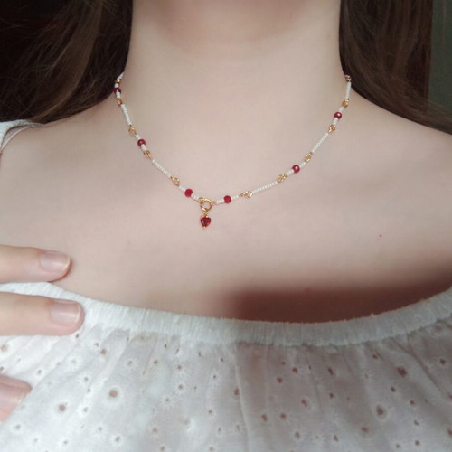 Rosary necklace with white and red beads and heart pendant