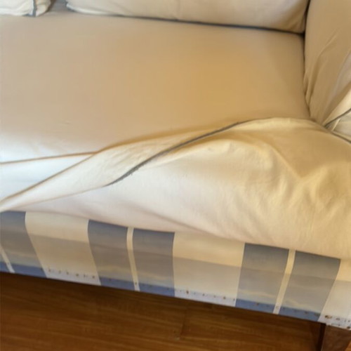 Two-seater sofa like new with ivory cover and grey-blue stitching