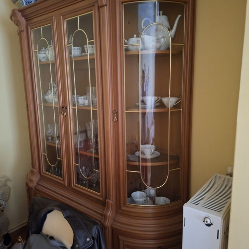 Wooden display cabinet with curved glass
