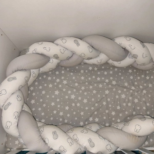 Baby braided crib bumper used in gray and white