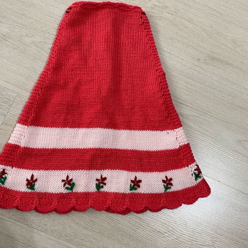 Handmade knitted baby dress in red and pink shades