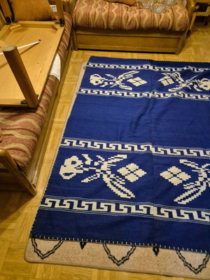 Blue handmade wool rug with pixel flower pattern like new