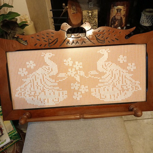 Handmade carved frame with crocheted peacocks design