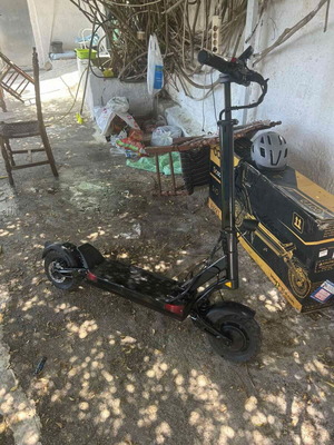 Joyor T10 Electric Scooter like new with two chargers, helmet, and brake fluid kit