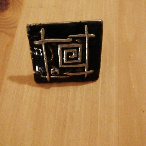 Square statement ring used with black enamel and silver geometric design
