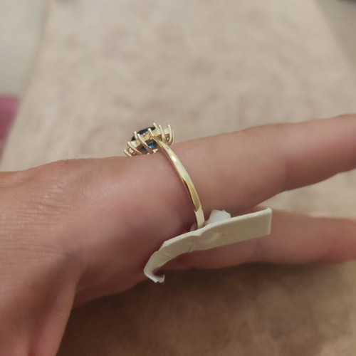 Women's rosetta ring new, gold color with blue oval stone and zircons