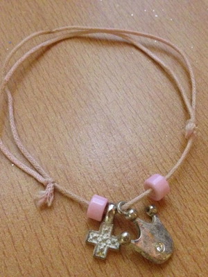 Pink bracelet with beads, cross and crown, used