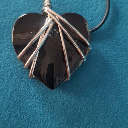 Heart necklace like new, black and silver with bindings