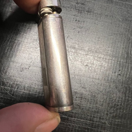 Silver lighter used, unknown if working