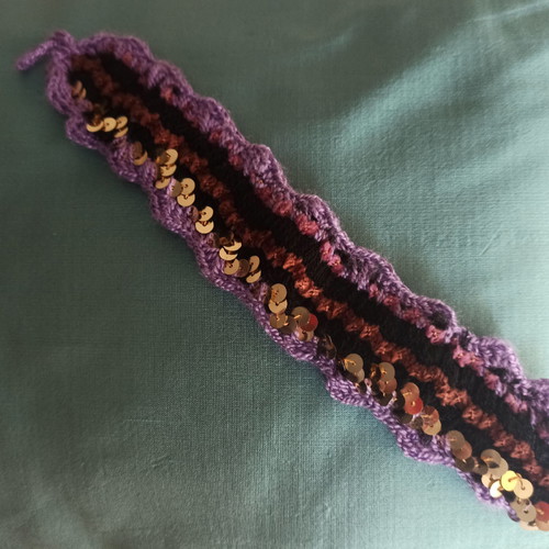 Boho knitted bracelet like new with purple and gold sequins