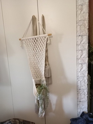 Two knitted wall hangers for pots, different sizes