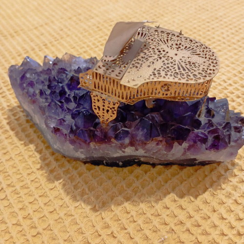 Vintage decorative piano on natural amethyst rock, gold-plated