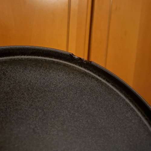 Porcelain plate used, black with small chip