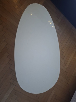 Modern white coffee table used with wooden legs, oval shape
