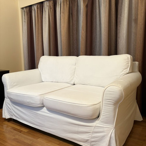 Two-seater sofa with white fabric cover like new