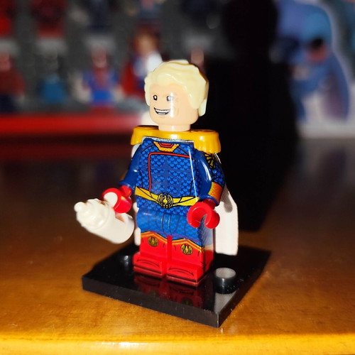 Homelander figure like new with base, two heads, cape, and bottle