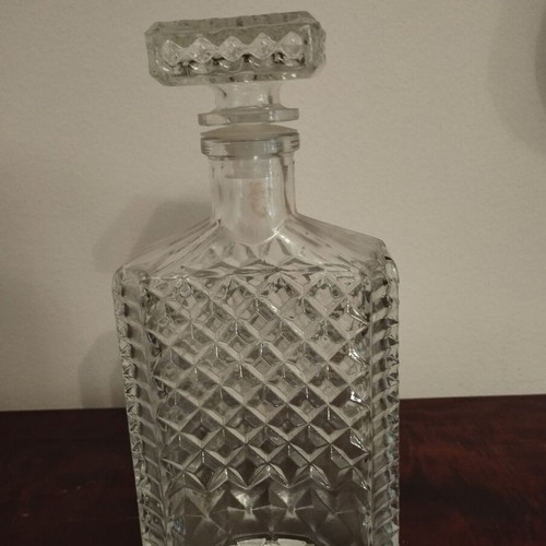Glass whiskey bottle with embossed design and square stopper, 1980s